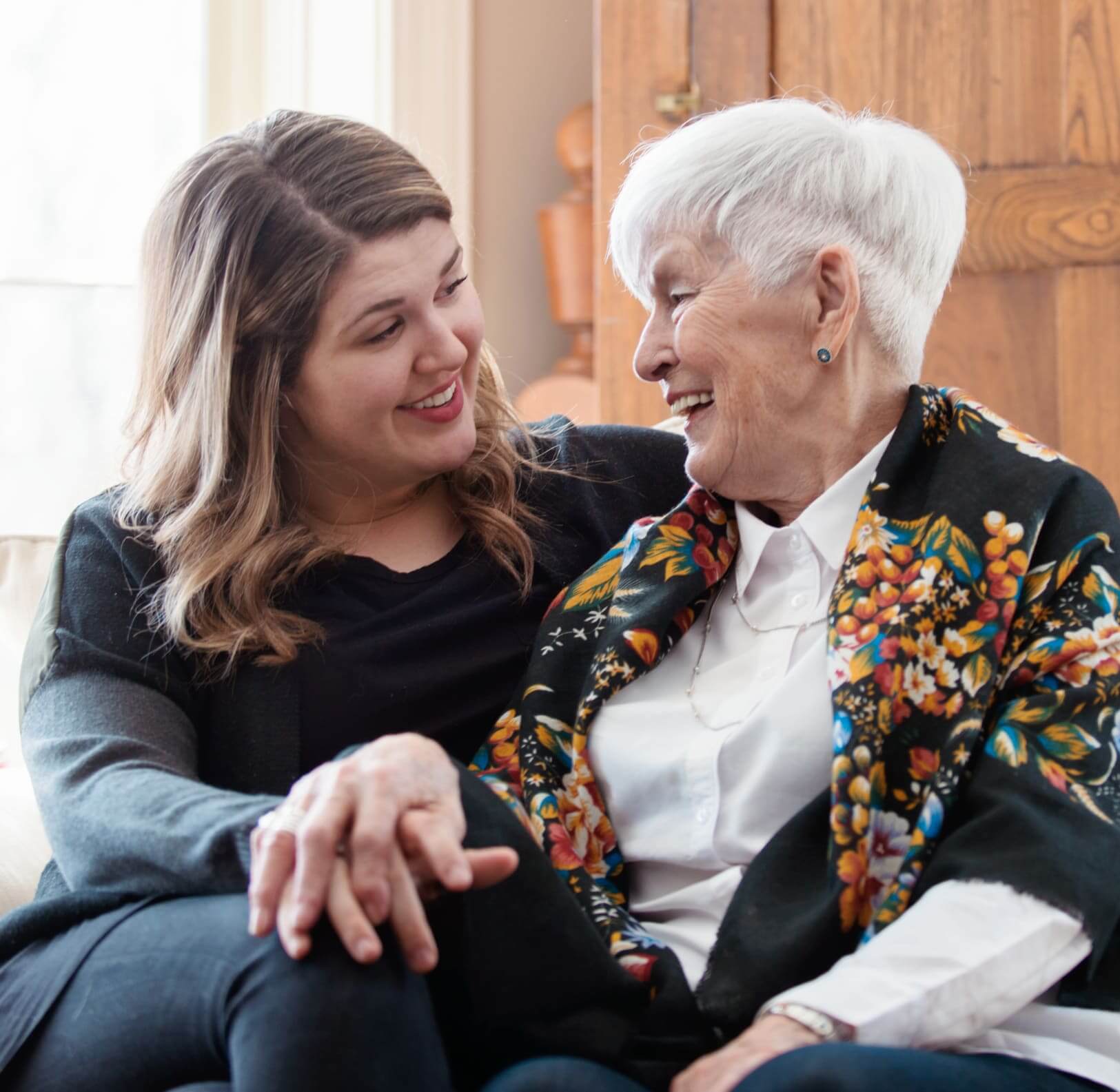Caregiver assisting a memory care resident during the evening at Village on the Park Rogers.